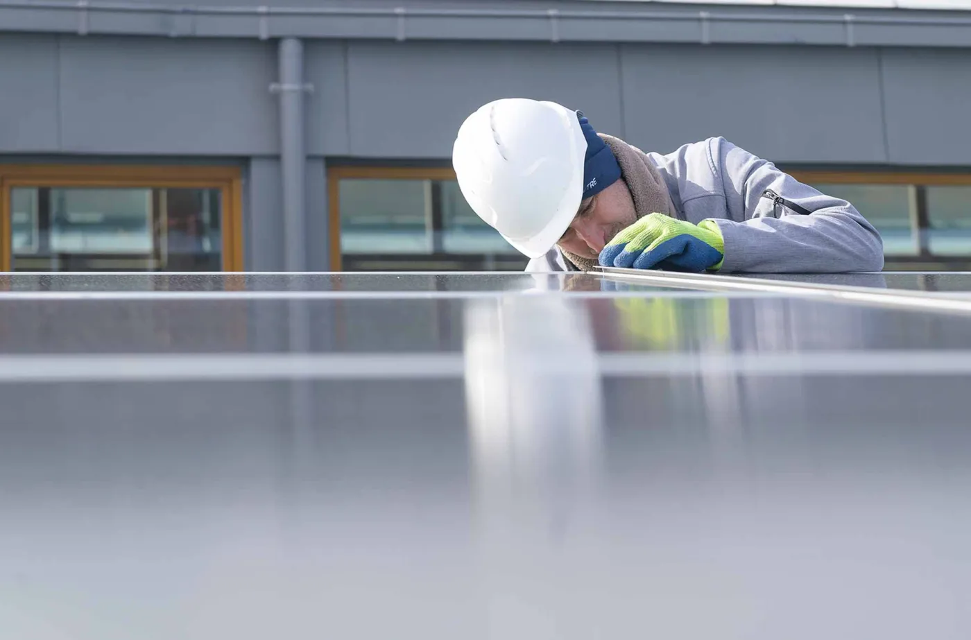 Un professionnel installe des panneaux solaires sur un toit