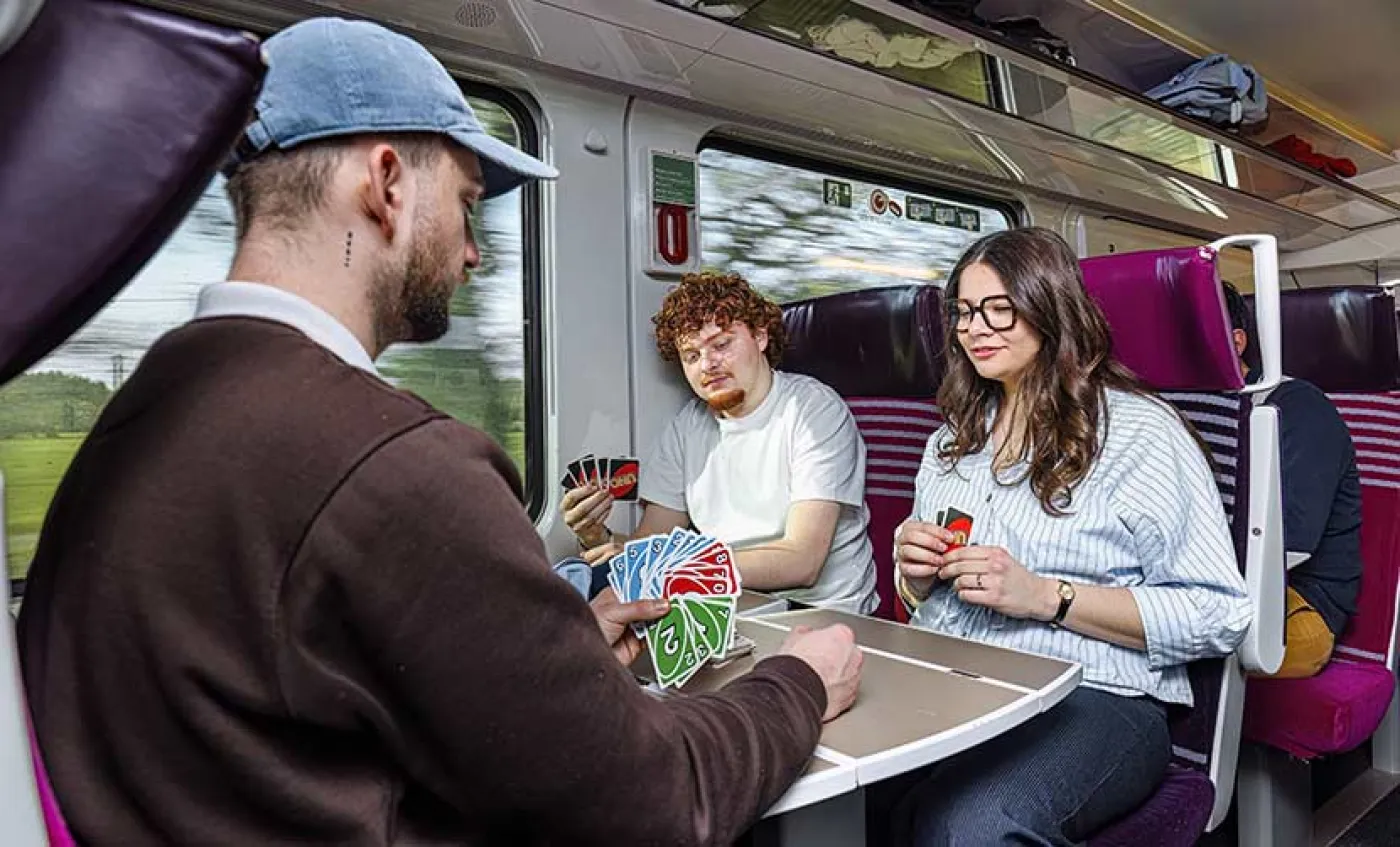 Des lycéens jouent aux cartes dans un train